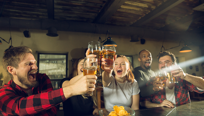 sport-fans-cheering-bar-pub-drinking-beer-while-championship-competition-is-going